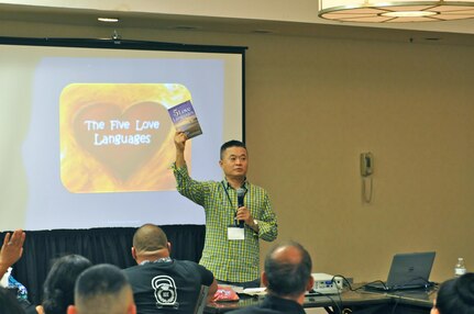 Chaplain (Lt. Col.) Sung Kim, Strong Bonds program director, 63rd Regional Support Command, holds up a copy of the ‘5 Love Languages’ book during a training session at the married couple portion of the 63rd RSC’s latest Strong Bonds event, for both single Soldiers and married couples, Sept. 2, at the Sheraton Hotel, San Diego. Strong Bonds uses teaching techniques that utilize an Army approved curriculum and is facilitated by Chaplains. (Army Reserve photo by Alun Thomas)