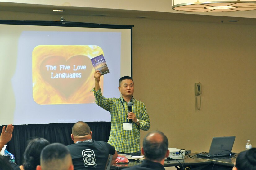 Chaplain (Lt. Col.) Sung Kim, Strong Bonds program director, 63rd Regional Support Command, holds up a copy of the ‘5 Love Languages’ book during a training session at the married couple portion of the 63rd RSC’s latest Strong Bonds event, for both single Soldiers and married couples, Sept. 2, at the Sheraton Hotel, San Diego. Strong Bonds uses teaching techniques that utilize an Army approved curriculum and is facilitated by Chaplains. (Army Reserve photo by Alun Thomas)