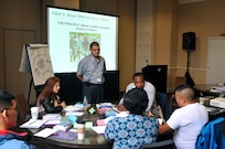 Chaplain (Maj.) Adrian Obrian (standing), Strong Bonds program manager, 63rd Regional Support Command, listens as a participant explains how he felt improperly used in an Army training mission, during the single Soldier portion of the 63rd RSC’s latest Strong Bonds event, for both single Soldiers and married couples, Sept. 3, at the Sheraton Hotel, San Diego. Strong Bonds uses teaching techniques that utilize an Army approved curriculum and is facilitated by Chaplains. (Army Reserve photo by Alun Thomas)