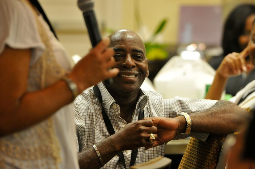 Willie Floyd smiles as his wife Sgt. 1st Class Georgette Alvez, from Fort Hunter Liggett, Calif., describes how they initially met each other, during the opening introductions at the married couple portion of the 63rd Regional Support Command’s latest Strong Bonds event for both single Soldiers and married couples, Sept. 2, at the Sheraton Hotel, San Diego. Strong Bonds uses teaching techniques that utilize an Army approved curriculum and is facilitated by Chaplains. (Army Reserve photo by Alun Thomas)