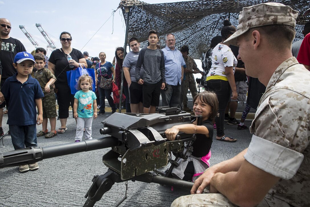 U.S. Marine Cpl. Jacob Kikta, machine gunner with Weapons Company, 3rd Battalion, 5th Marine Regiment, teaches children about the MK-19 Grenade Launcher, during a static display demonstration at Los Angeles Fleet Week in San Pedro, Calif., Sept. 4, 2016. L.A. Fleet Week is an event designed to showcase the capabilities of the Navy-Marine Corps team to L.A. residents, and an opportunity for members of the sea services to meet and thank the community for its support. (U.S. Marine Corps photo by Sgt. Rick Hurtado)