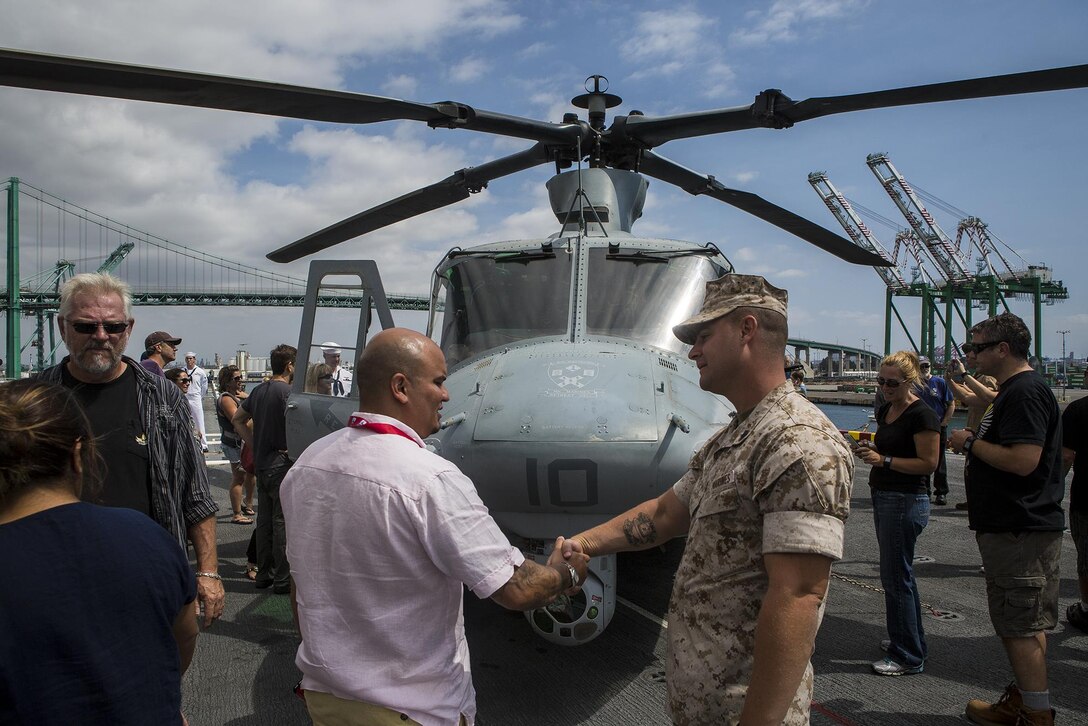 U.S. Marine Gunnery Sgt. Nathan Hanley, squadron gunnery sergeant for Marine Light Attack Helicopter Squadron 369, meets and greets members of the Los Angeles community and surrounding areas during a static display demonstration at Los Angeles Fleet Week in San Pedro, Calif., Sept. 4, 2016. L.A. Fleet Week is an event designed to showcase the capabilities of the Navy-Marine Corps team to L.A. residents, and an opportunity for members of the sea services to meet and thank the community for its support. (U.S. Marine Corps photo by Sgt. Rick Hurtado)