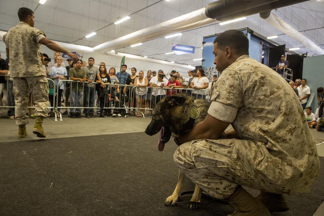 U.S. Marine Staff Sgt. Octavio Gonzalez, left, and U.S. Marine Cpl. Rafael Fuerteluna, both military working dog handlers with 1st Law Enforcement Battalion, I Marine Expeditionary Force Headquarters Group, currently attached to Task Force Los Angeles, answer questions from members of the community about Uwe, a military working dog, during a demonstration at Los Angeles Fleet Week in San Pedro, Calif., Sept. 4, 2016. L.A. Fleet Week is an event designed to showcase the capabilities of the Navy-Marine Corps team to L.A. residents, and an opportunity for members of the sea services to meet and thank the community for its support. (U.S. Marine Corps photo by Sgt. Rick Hurtado)