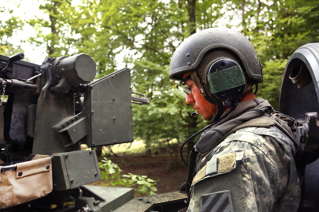 A soldier listens to radio communications in an M1A2 Abrams tank during defensive operations training as part of the Combined Resolve VII exercise at Hohenfels, Germany, Sept. 2, 2016. The soldier is assigned to Company R, 2nd Battalion, 7th Infantry Regiment, 1st Armored Brigade. Army photo by Pfc. Caleb Foreman