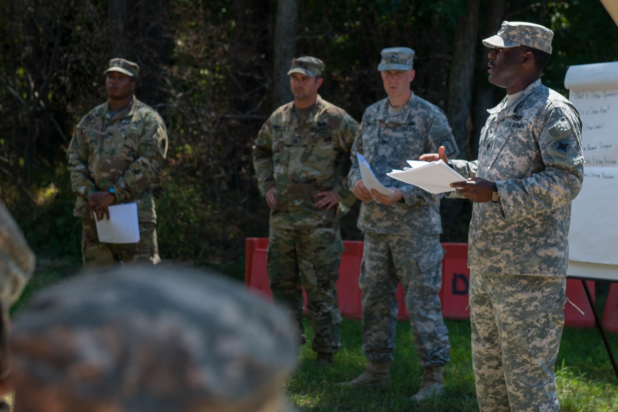 U.S. Army Soldiers attending an Advanced Leadership Course, give a briefing on urban operations at Fort Eustis, Va., Aug. 29, 2016. Three main points of conducting urban operations are performing movement techniques, selecting hasty fire positions and performing clearing procedures. (U.S. Air Force photo by Airman 1st Class Derek Seifert)