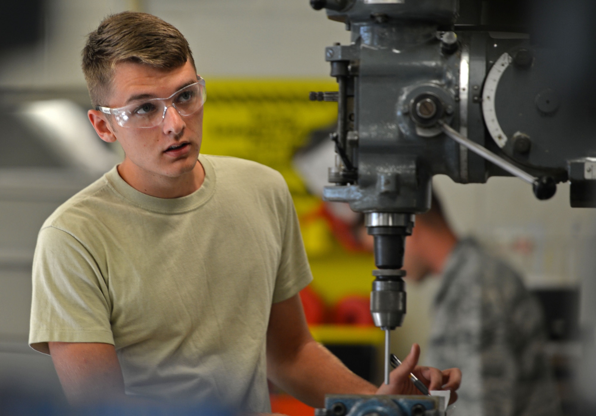 U.S. Air Force Airman 1st Class Justin Romaca, 20th Equipment Maintenance Squadron metals technology apprentice, uses a mill to drill holes into an F-16CM Fighting Falcon flap mount at Shaw Air Force Base, S.C., Sept. 7, 2016. Airmen assigned to the 20th EMS metals technology lab inspected and measured the holes to ensure they meet safety standards before placement onto an F-16. (U.S. Air Force photo by Airman 1st Class Christopher Maldonado) 