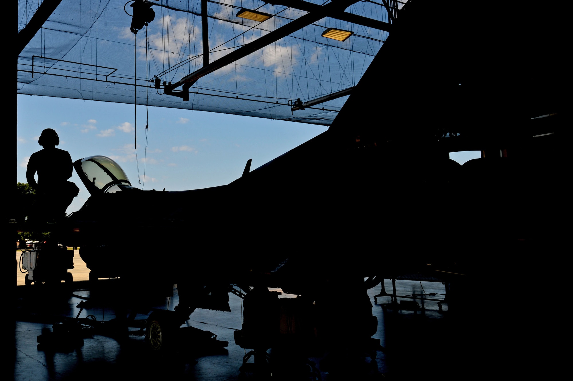 U.S. Air Force Airman 1st Class Nicholas Samudio, 20th Equipment Maintenance Squadron aircraft structural maintenance apprentice, prepares to walk off the wing of an F-16CM Fighting Falcon at Shaw Air Force Base, S.C., Sept. 7, 2016. Airmen assigned to the 20th EMS aircraft structural maintenance flight perform various installations and removal of F-16 parts to include flap mounts. (U.S. Air Force photo by Airman 1st Class Christopher Maldonado)