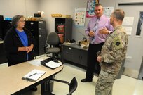 David Graham, center, a heavy mobile equipment repair supervisor for Area Maintenance Support Activity (AMSA) 56, speaks to Maj. Gen. Patrick Reinert, commanding general of 88th Regional Support Command, about the job Sara Swango, left, a maintenance administrative supply technician, does to keep AMSA 56 ready to meet the maintenance needs of the more than 90 units it supports.