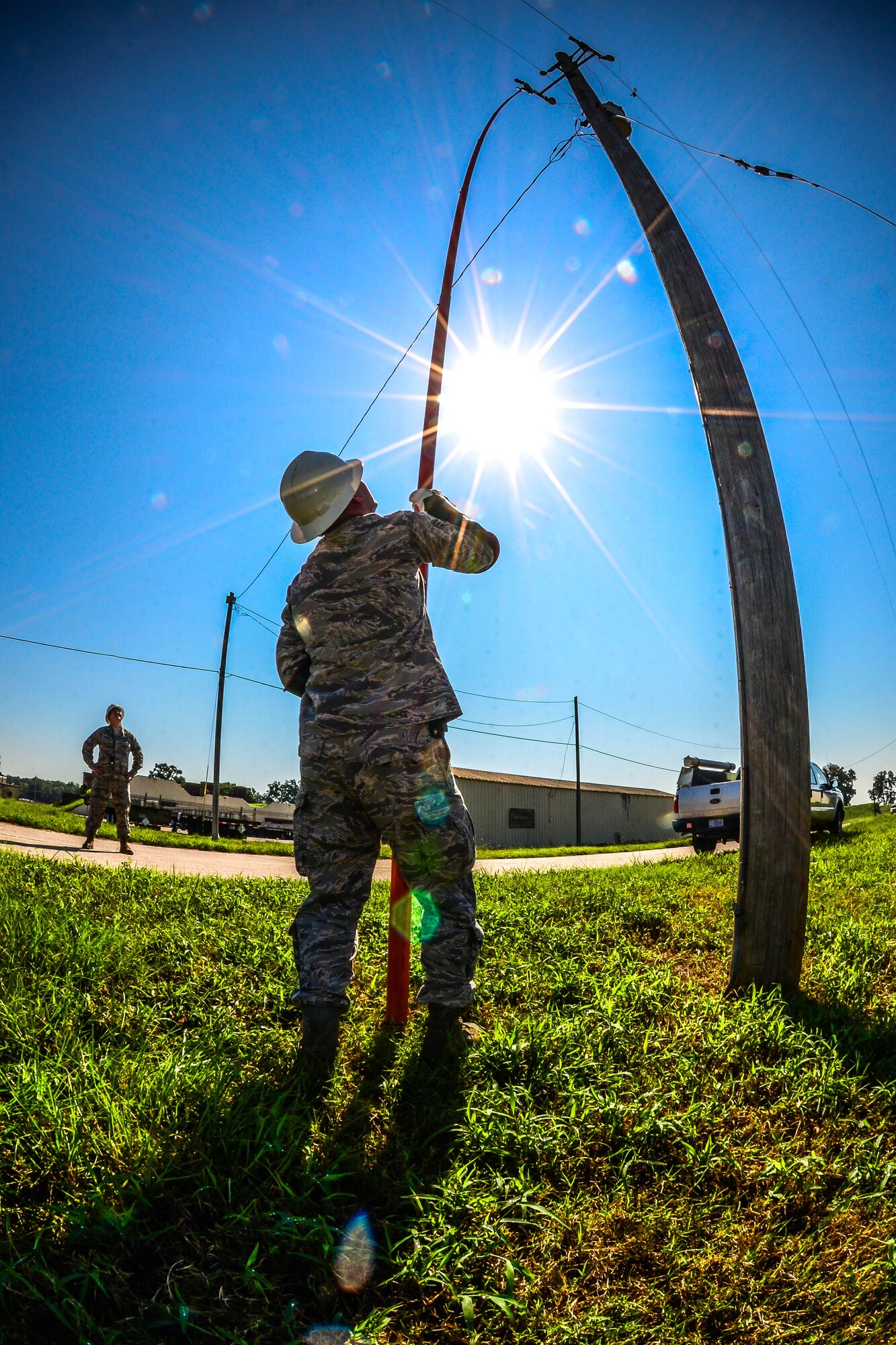Senior Airman James Scott, 2nd Civil Engineer Squadron electrical systems craftsman, uses an extension pole to remove a broken fuse from a power line at Barksdale Air Force Base, La., Aug. 31, 2016. During an outage, electrical systems Airmen must restore power to mission essential equipment first before restoring power to the rest of the base. (U.S. Air Force photo/Senior Airman Luke Hill)