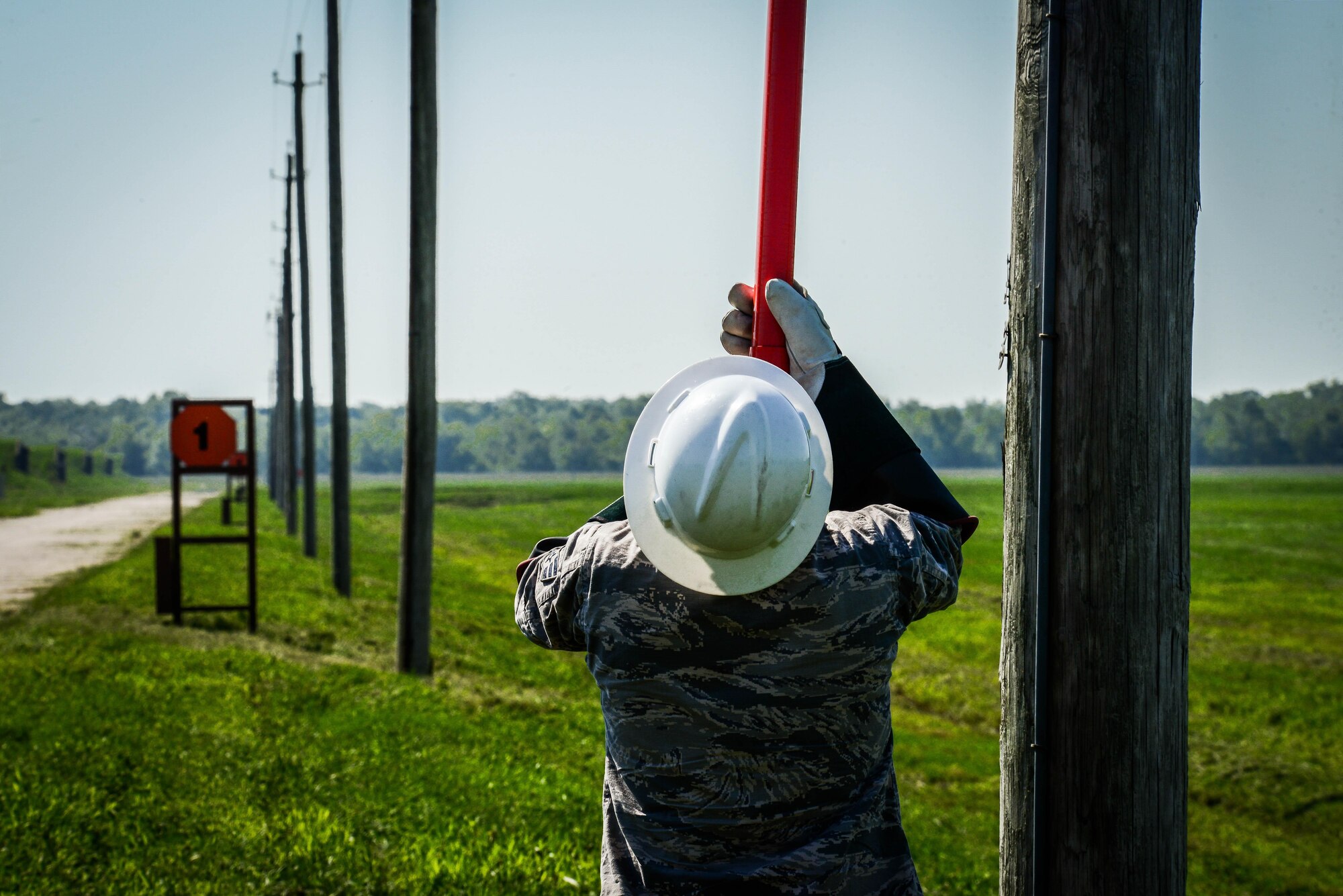 Senior Airman James Scott, 2nd Civil Engineer Squadron electrical systems craftsman, uses an extension pole to remove a broken fuse from a power line at Barksdale Air Force Base, La., Aug. 31, 2016. During a power outage, electric systems Airmen must drive to the location, find the power outage, and fix the problem. (U.S. Air Force photo/Senior Airman Luke Hill)