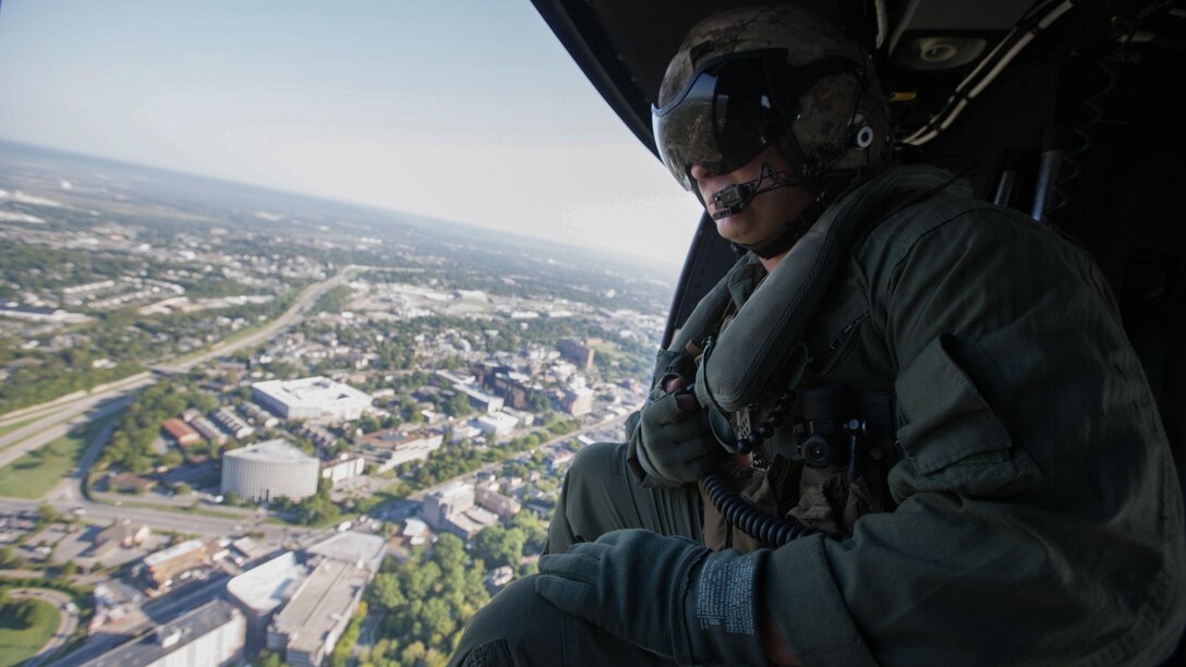 U.S. Marine Corps Sgt. Cody Rainey, a crew chief with Marine Light Attack Helicopter Squadron (HMLA) 167, sits inside of a UH-1Y Huey as it flies above Nashville, TN., Sept. 6, 2016 during Marine Week. Marine Week Nashville is an opportunity to showcase the Marines and help people understand the capabilities of the Marine Corps. 