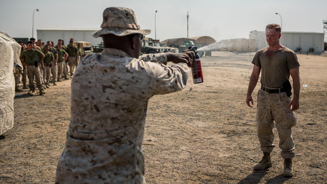 U.S. Marine Corps Sgt. Dylan Zuccherino (right), a forward observer with Detachment N, 3rd Air Naval Gunfire Liaison Company, Special Purpose Marine Air-Ground Task Force - Crisis Response - Central Command 16.2, is contaminated with Oleoresin Capsicum spray during an OC qualification course at an undisclosed location in Southwest Asia, Aug. 27, 2016. SPMAGTF-CR-CC is a self-sustaining expeditionary unit, designed to provide a broad range of crisis response capabilities. 