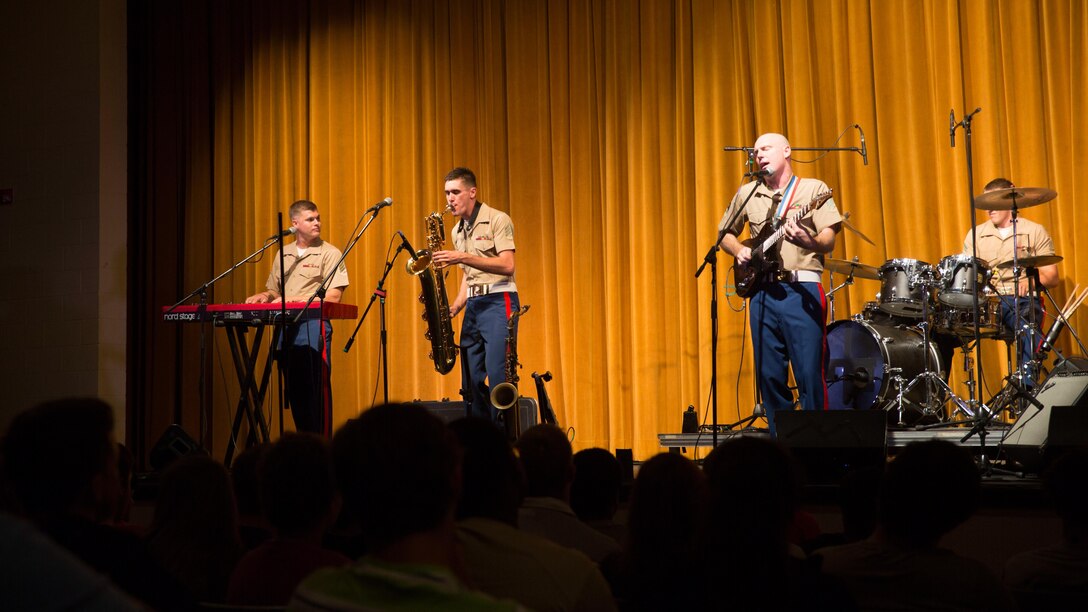 Marines with the San Diego Marine Band's Rock Band perform at Springfield High School in Springfield, Tenn. as part of Marine Week Nashville, Sept. 6, 2016. The concert was held to provide Marines with an opportunity to speak with eligible prospects, key influencers and educators, and promote the Music Enlistment Option Program. Marine Week, an annual event held in a different city each year, is a celebration of Community, Country and Corps that allows the public to learn about the Corps through hands-on static displays, live demonstrations, time-honored Marine Corps traditions, musical performances and more.
