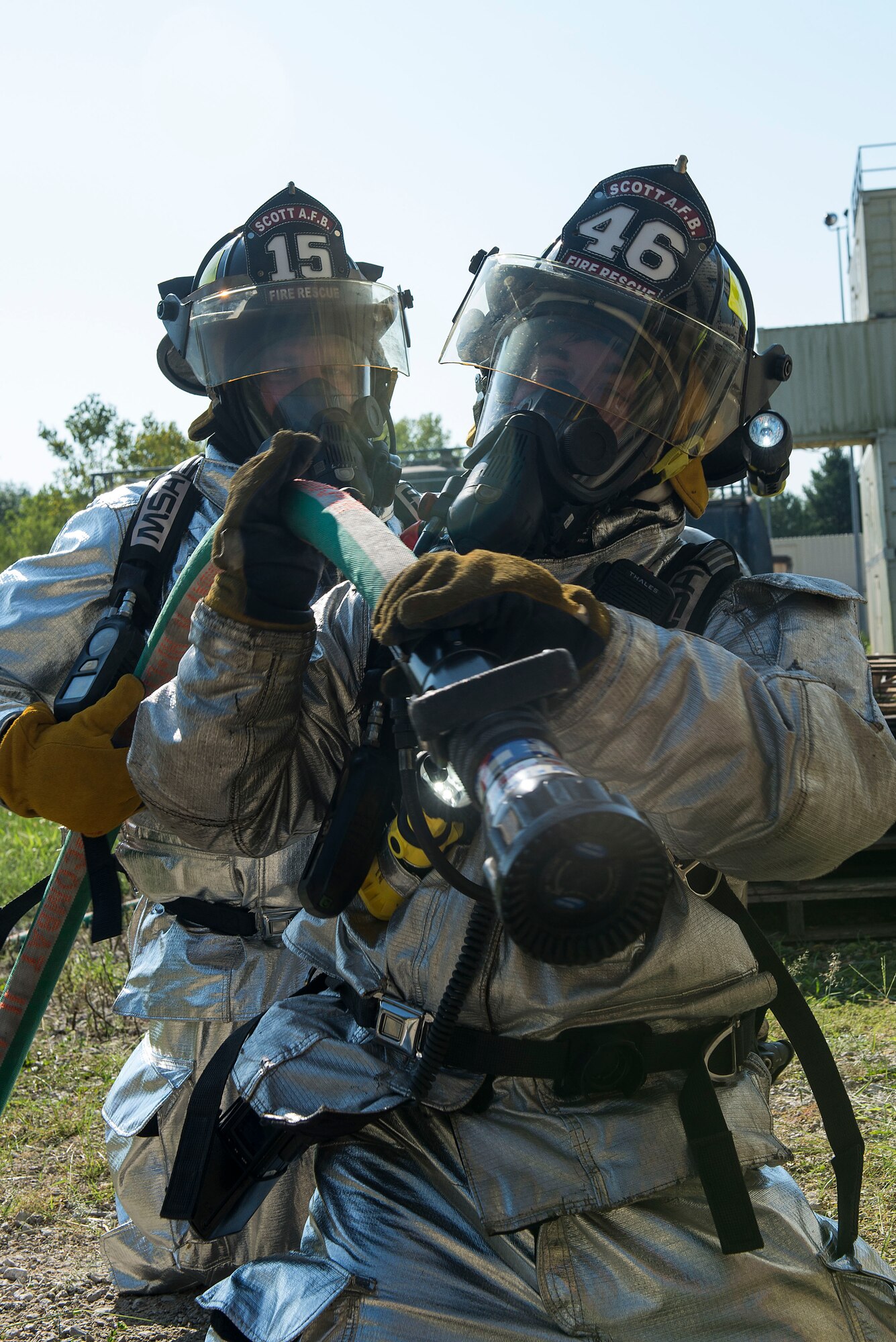 Firefighters with the 375th Civil Engineer Squadron prepare a hose while participating in an instructor credentialing course at Scott Air Force Base, Ill., Aug. 31, 2016. The three-day training program explored the most recent National Fire Protection Association standards and applied principles of the standards to the student’s ability to instruct live fire training in a safe environment. (U.S. Air Force photo/Tech. Sgt. Jonathan Fowler)