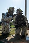 Two 375th Civil Engineer Squadron firefighters discuss tactics and procedures during a training scenario at Scott Air Force Base, Ill., Aug. 31, 2016. The scenario was part of an instructor training course and was specifically designed to test an instructor’s ability to work with students in fire conditions to include physical positioning, maneuvering in low visibility, observations of difficulties students are having and unsafe behavior. (U.S. Air Force photo/Tech. Sgt. Jonathan Fowler)