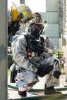 Two 375th Civil Engineer Squadron firefighters prepare to enter a building during a live fire training scenario at Scott Air Force Base, Ill., Aug. 31, 2016. The scenario was part of an instructor training course designed to test instructors in numerous ways such as their situational awareness during fire operations, looking for changes in dynamics and conditions, student behavior, operational issues and compliance with safety plans. (U.S. Air Force photo/Tech. Sgt. Jonathan Fowler)