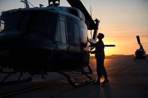 Capt. Sarah Morris, 11th Wing chaplain, blesses a UH-1N Huey on the flightline at Joint Base Andrews, Md., Aug. 31, 2016. Chaplains bless aircraft with hopes to keep Airmen and aircraft safe through their time in service. (U.S. Air Force photo by Senior Airman Philip Bryant)