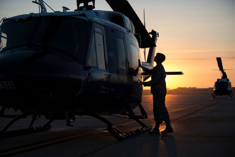 Capt. Sarah Morris, 11th Wing chaplain, blesses a UH-1N Huey on the flightline at Joint Base Andrews, Md., Aug. 31, 2016. Chaplains bless aircraft with hopes to keep Airmen and aircraft safe through their time in service. (U.S. Air Force photo by Senior Airman Philip Bryant)