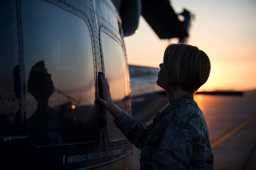 Capt. Sarah Morris, 11th Wing chaplain, blesses a UH-1N Huey on the flightline at Joint Base Andrews, Md., Aug. 31, 2016. Chaplains bless aircraft with hopes to keep Airmen and aircraft safe through their time in service. (U.S. Air Force photo by Senior Airman Philip Bryant)