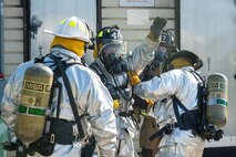 Firefighters with the 375th Civil Engineer Squadron check each other’s suits prior to the beginning a training exercise at Scott Air Force Base, Ill., Aug. 31, 2016. The training featured firefighters from multiple bases and from the local community to include the 628th CES from Joint Base Charleston, South Carolina, the 19th CES from Little Rock AFB, Arkansas, the Mehlville Fire Protection District from St. Louis, Missouri, and the St. Louis Public Schools. (U.S. Air Force photo/Tech. Sgt. Jonathan Fowler)