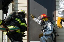 Firefighters from various organizations enter a building as part of a training scenario at Scott Air Force Base, Ill., Aug. 31, 2016. The training was part of a three-day live fire, fixed facility credentialing course developed by the International Society of Fire Service Instructors. The program explored the most recent National Fire Protection Association standards and applied principles of the standards to the student’s ability to instruct live fire training in a safe environment. (U.S. Air Force photo/Tech. Sgt. Jonathan Fowler)