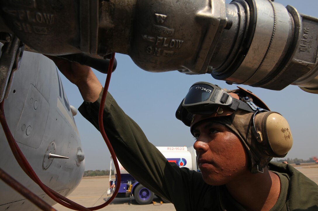 U.S. Marine Corps Lance Cpl. Rudy Martinez, a powerliner from Marine All Weather Fighter Attack Squadron 242, Marine Aircraft Group 12, 1st Marine Aircraft Wing, III Marine Expeditionary Force, watches over the refueling process of an F-18 Hornet after flight operations at Korat Royal Thai Air Force Base, Feb. 11, during Exercise Cobra Gold 2011. Cobra Gold is an regularly scheduled annual multinational training exercise. It is the latest in the continuing series of U.S. - Thai military exercises designed to ensure regional peace and stability.