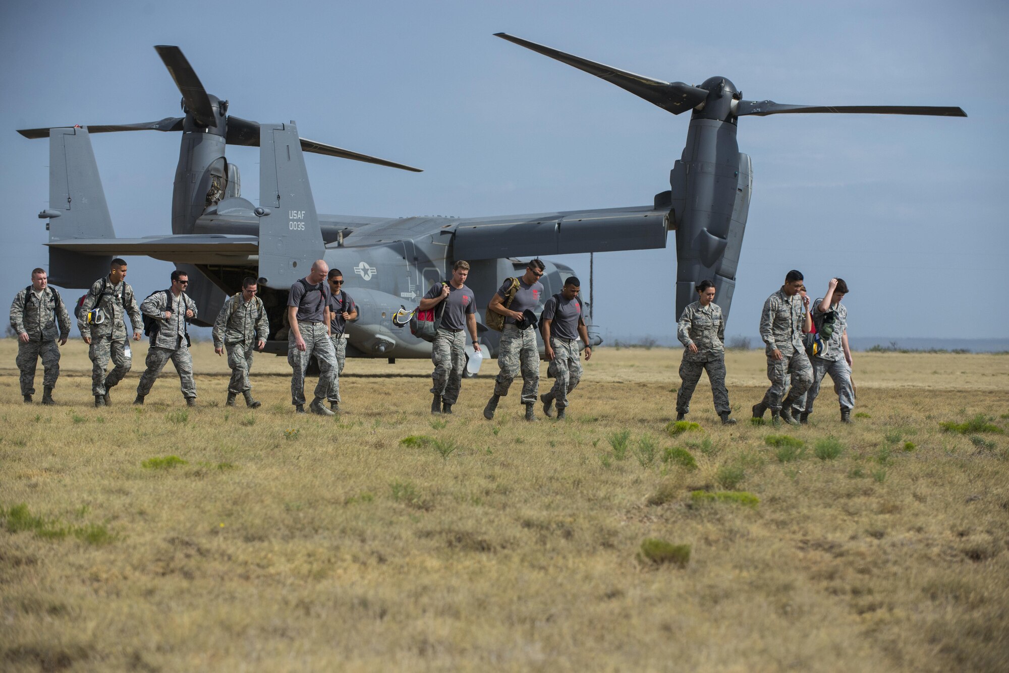 U.S. Air Force Airmen exit a CV-22 Osprey aircraft, assigned to Cannon Air Force Base, N.M., before the start of the 2016 Emergency Medical Technician Rodeo at Melrose Air Force Range, N.M., Aug. 25, 2016. Cannon’s EMT Rodeo tests the skills of medical professionals from across the Air Force through a series of innovative, high-pressure scenarios. (U.S. Air Force photo by Senior Airman Luke Kitterman/Released)