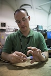 Kane Ivory, an electrical engineer from Melbourne, Australia, adds thermal couplers and a heating cartridge to a lithium ion cell to run a thermal abuse test on the cell in West Bethesda, Md., Aug. 29, 2016. Ivory is temporarily assigned to Naval Surface Warfare Center, Carderock Division under the Department of Defense's Engineer and Scientist Exchange Program. (U.S. Navy photo by Dustin Q. Diaz/Released)