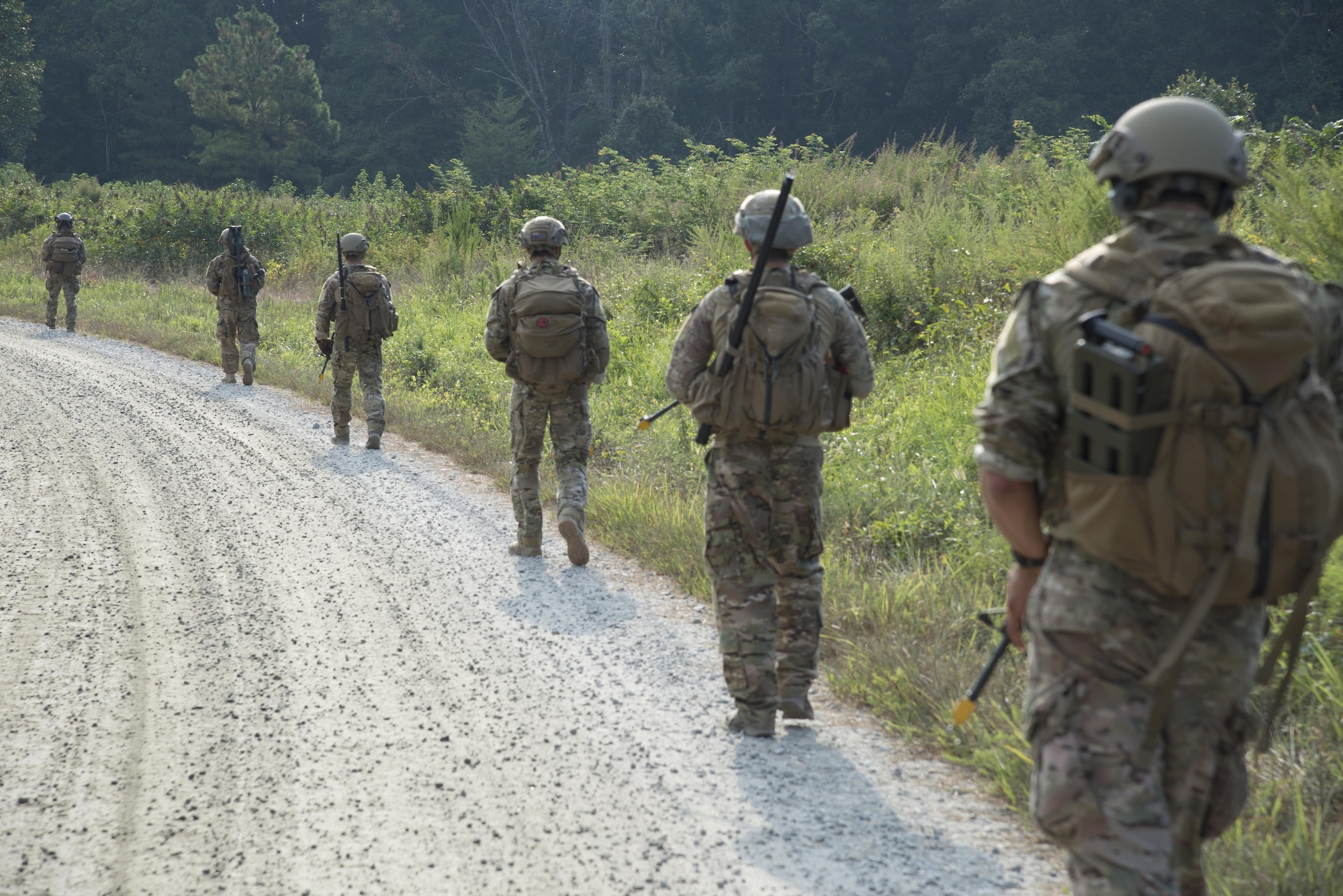 U.S Air Force Airmen assigned to the 633rd Civil Engineer Squadron Explosive Ordinance Disposal team ruck march toward their training grounds at Fort Pickett, Va., Aug. 31, 2016. After arriving at the training grounds, the team was briefed on the scenarios they would be working on. (U.S. Air Force photo by Airman First Class Enrique Barcelo)