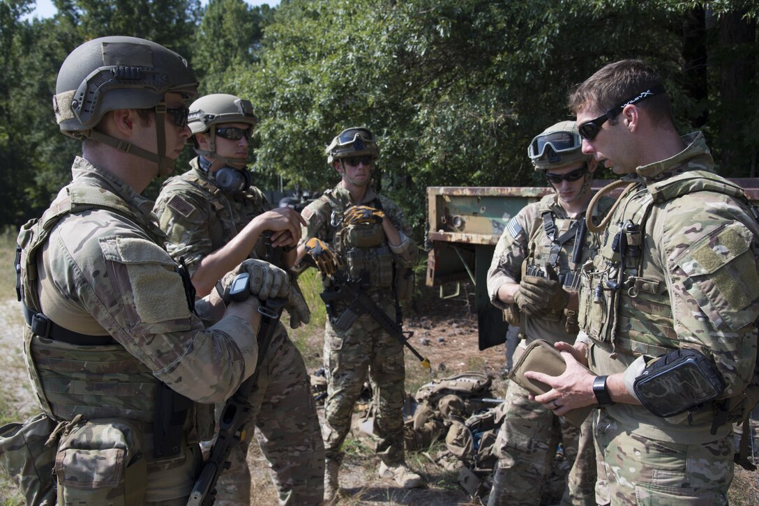 U.S. Air Force Tech. Sgt. Korrey Baird, 633rd Civil Engineer Squadron Explosive Ordinance Disposal section chief, debriefs his team members after the completion of their training exercise at Fort Pickett, Va., Aug. 31, 2016. The team learned techniques used in identifying and disarming live explosives. (U.S. Air Force photo by Airman First Class Enrique Barcelo)