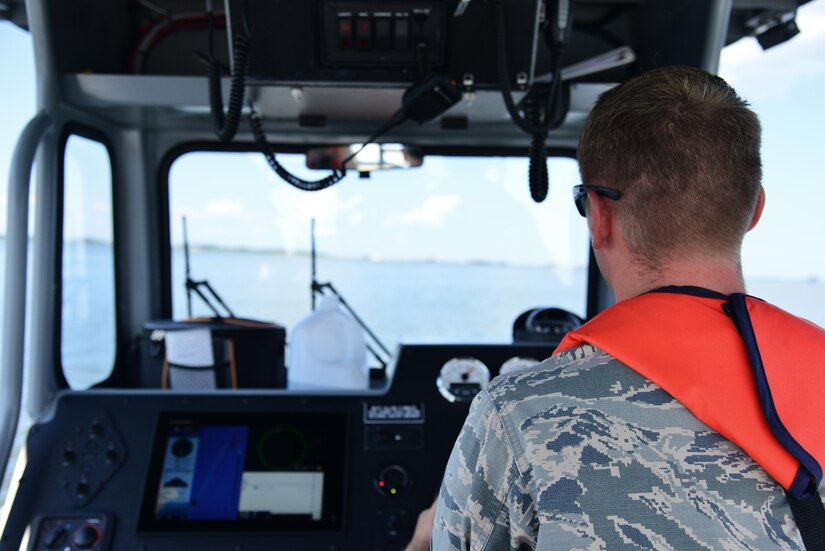 U.S. Air Force Staff Sgt. Shawn McNamara, 633rd Security Forces Squadron boat patrolman, scans the water during a routine patrol in the Back River, Va., Aug. 17, 2016. The boat patrol unit is not used solely for base security purposes, they also help local agencies with search and rescues. (U.S. Air Force photo by Airman 1st Class Tristan Biese)