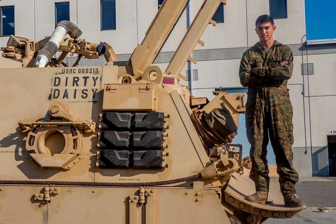 Cpl. Calletano Jimenez stands on the M88A2 Hercules Recovery Vehicle he maintains at Camp Pendleton, Calif., Aug, 31, 2016. Jimenez is a tank mechanic with 1st Maintenance Battalion, Combat Logistics Regiment 15, 1st Marine Logistics Group who was recently awarded the Maintenance Marine of the Year Award by the Ground Ordnance Maintenance Association for his outstanding achievements in maintenance of military equipment and weapon systems. (U.S. Marine Corps photo by Lance Cpl. Kyle McNan/released)