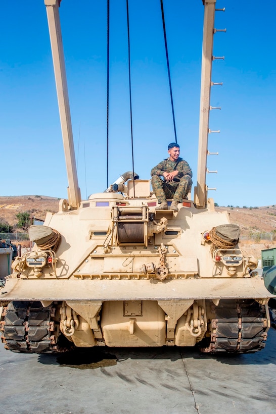 Cpl. Calletano Jimenez sits atop the M88A2 Hercules Recovery Vehicle he maintains at Camp Pendleton, Calif., Aug, 31, 2016. Jimenez is a tank mechanic with 1st Maintenance Battalion, Combat Logistics Regiment 15, 1st Marine Logistics Group who was recently awarded the Maintenance Marine of the Year Award by the Ground Ordnance Maintenance Association for his outstanding achievements in maintenance of military equipment and weapon systems. (U.S. Marine Corps photo by Lance Cpl. Kyle McNan/released)
