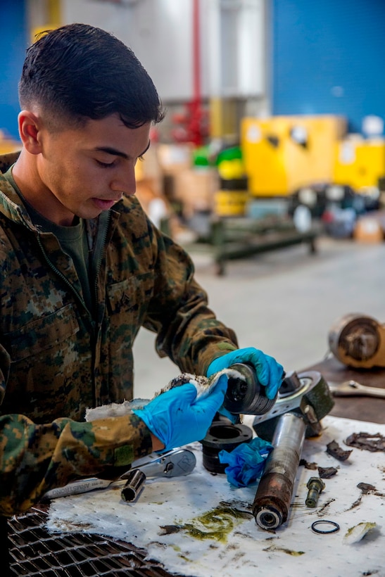 Cpl. Calletano Jimenez in his workshop at Camp Pendleton, Calif., Aug, 31, 2016. Jimenez is a tank mechanic with 1st Maintenance Battalion, Combat Logistics Regiment 15, 1st Marine Logistics Group who was recently awarded the Maintenance Marine of the Year Award by the Ground Ordnance Maintenance Association for his outstanding achievements in maintenance of military equipment and weapon systems. (U.S. Marine Corps photo by Lance Cpl. Kyle McNan/released)