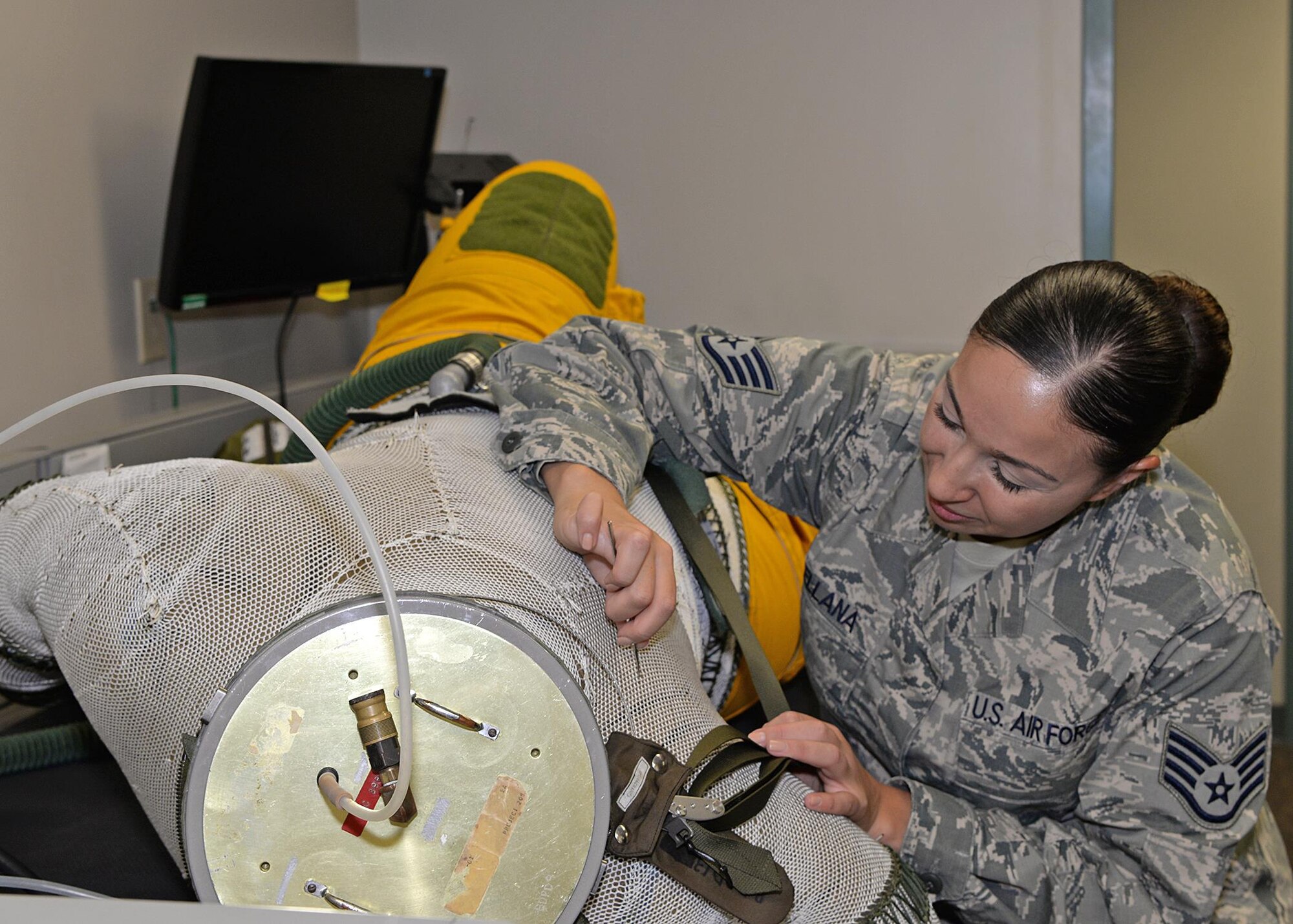 Staff Sgt. Julie Orellana, 9th Physiological Support Squadron full pressure suit technician, inspects and repairs the weave net on a full pressure suit Aug. 31, 2016, at Beale Air Force Base, California. The weave net helps the suit maintain its shape and stops it from over expanding. (U.S. Air Force photo/Airman Tristan D. Viglianco)