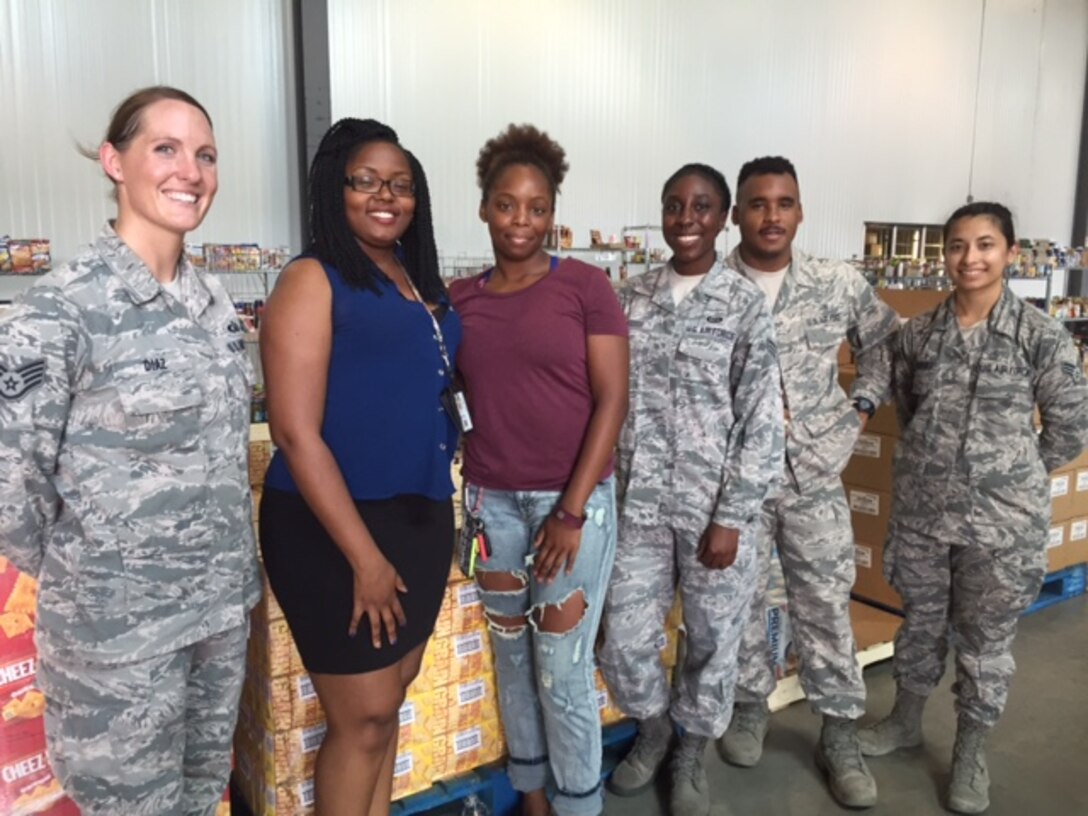 U.S. Air Force Airmen volunteer to sort through donations for the Feds Feed Families Food Drive held at Joint Base Langley-Eustis, Va., Sept. 1, 2016. JBLE members raised more than 1,520 pounds of food for the Virginia Peninsula food bank in Hampton, Virginia. (Courtesy photo)