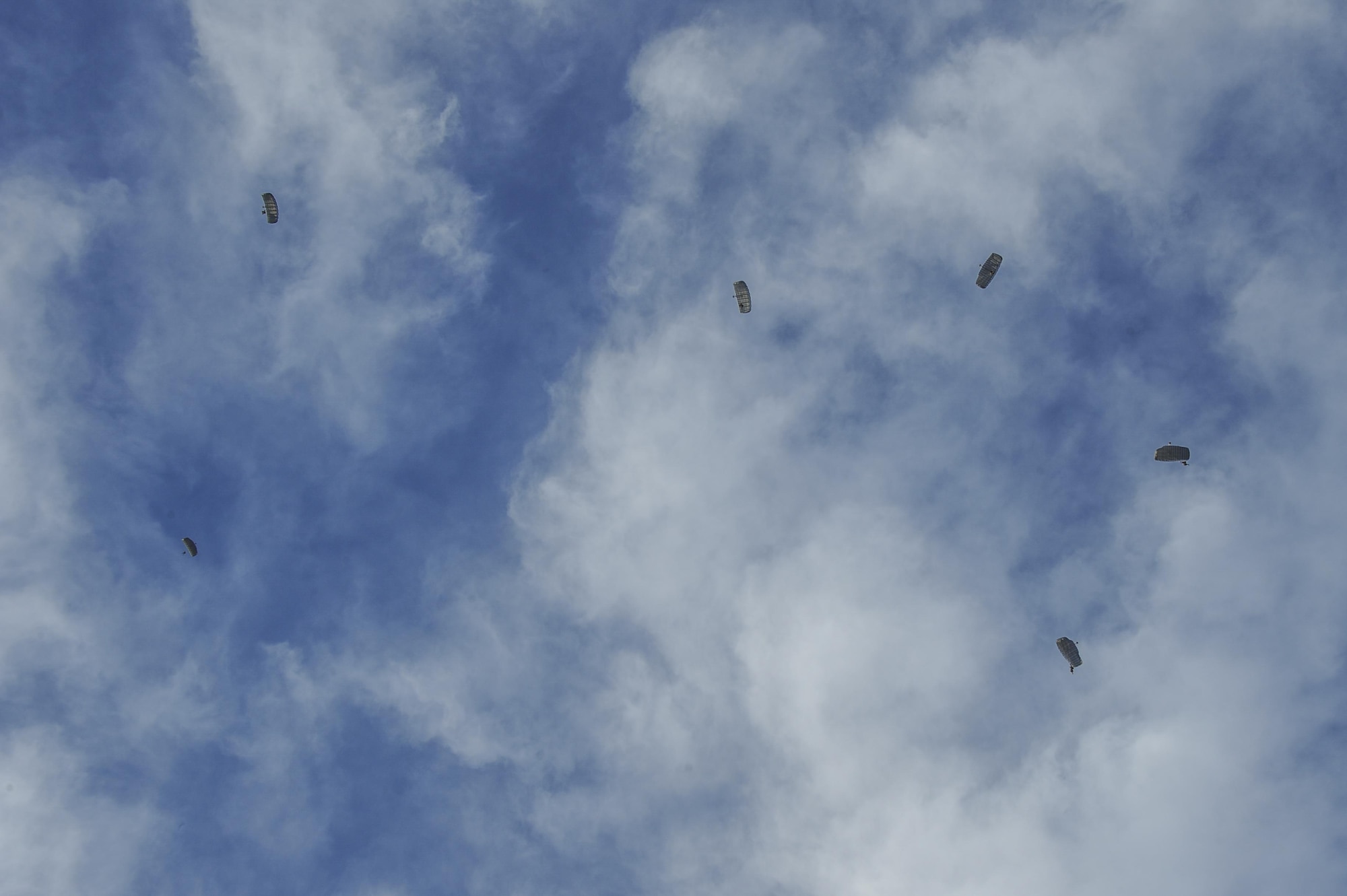 During a jump mission, Combat Leaders Course students parachute in formation in Florence, Ariz., Aug. 30, 2016. The students mission planned and executed a multitude of scenarios including a jump mission with an overland movement, a mass casualty, and a technical rescue with the rotary wing exfiltration all within the climates of southern Arizona and California.   (U.S. Air Force photo by Airman 1st Class Mya M. Crosby)