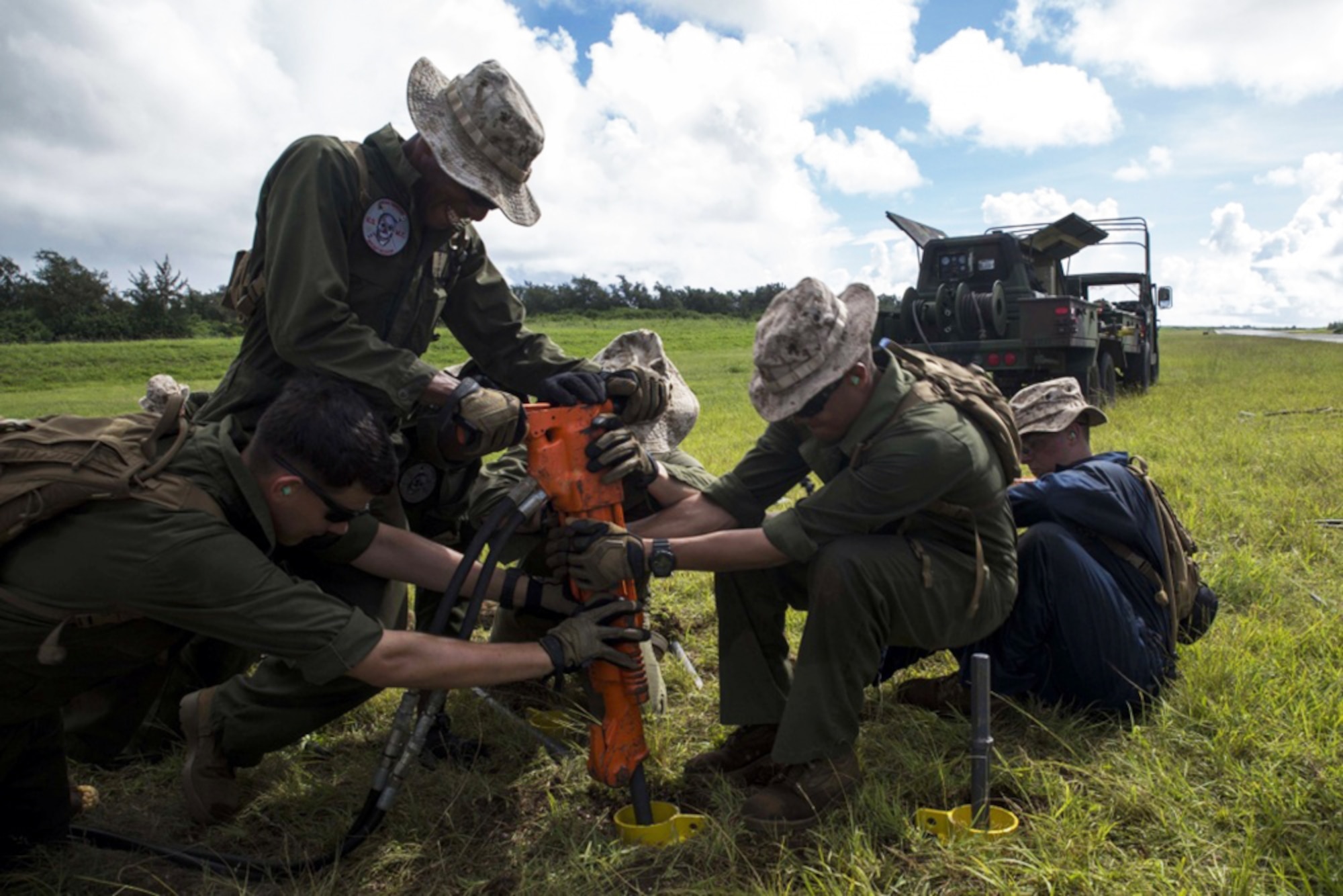 Marine expeditionary airfield systems technicians use a jackhammer to drive a steak into the ground as part of the M31 Marine Corps Expeditionary Arresting Gear System installation Sept. 6 at Tinian's West Field in preparation for Exercise Valiant Shield 2014. Arresting gear is used in order to land pilots in a short amount of space, or during an emergency. Valiant Shield is a biennial exercise which focuses on training that enables real-world proficiency in sustaining joint forces. The Marines are with Marine Wing Support Squadron 171 and MWSS-172, both under Marine Aircraft Group 12, 1st Marine Aircraft Wing, III Marine Expeditionary Force. (U.S. Marine Corps photo by Cpl. David A. Walters/Released)