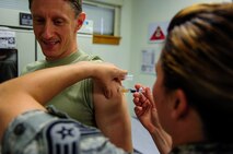 U.S. Air Force Lt. Col. George J. Buse, 8th Medical Group deputy commander, Chief of the Medical Staff, receives a flu vaccination from Staff Sgt. Jessica Smith, immunizations non-commissioned officer in charge, at the 8th Medical Group facility, Kunsan Air Base, Republic of Korea, Sept. 7, 2016. Flu vaccinations are given every fall to ensure the health of the airmen and readiness of the Air Force. (U.S. Air Force photo/ Senior Airman Colville McFee) 
