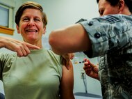 U.S. Air Force Col. Lisa A. Davison, 8th Medical Group commander, receives a flu vaccination from Staff Sgt. Jessica Smith, immunizations non-commissioned officer in charge, at the 8th Medical Group facility, Kunsan Air Base, Republic of Korea, Sept. 7, 2016. Flu vaccinations are given every fall to ensure the health of the airmen and readiness of the Air Force (U.S. Air Force photo/ Senior Airman Colville McFee) 