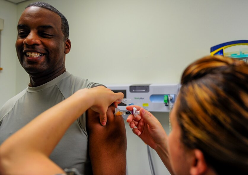 U.S. Air Force Chief Master Sgt. Bruce McKenzie, 8th Medical Group superintendent, receives a flu vaccination from Staff Sgt. Jessica Smith, immunizations non-commissioned officer in charge, at the 8th Medical Group facility, Kunsan Air Base, Republic of Korea, Sept. 7, 2016. Flu vaccinations are given every fall to ensure the health of the airmen and readiness of the Air Force (U.S. Air Force photo/ Senior Airman Colville McFee)
