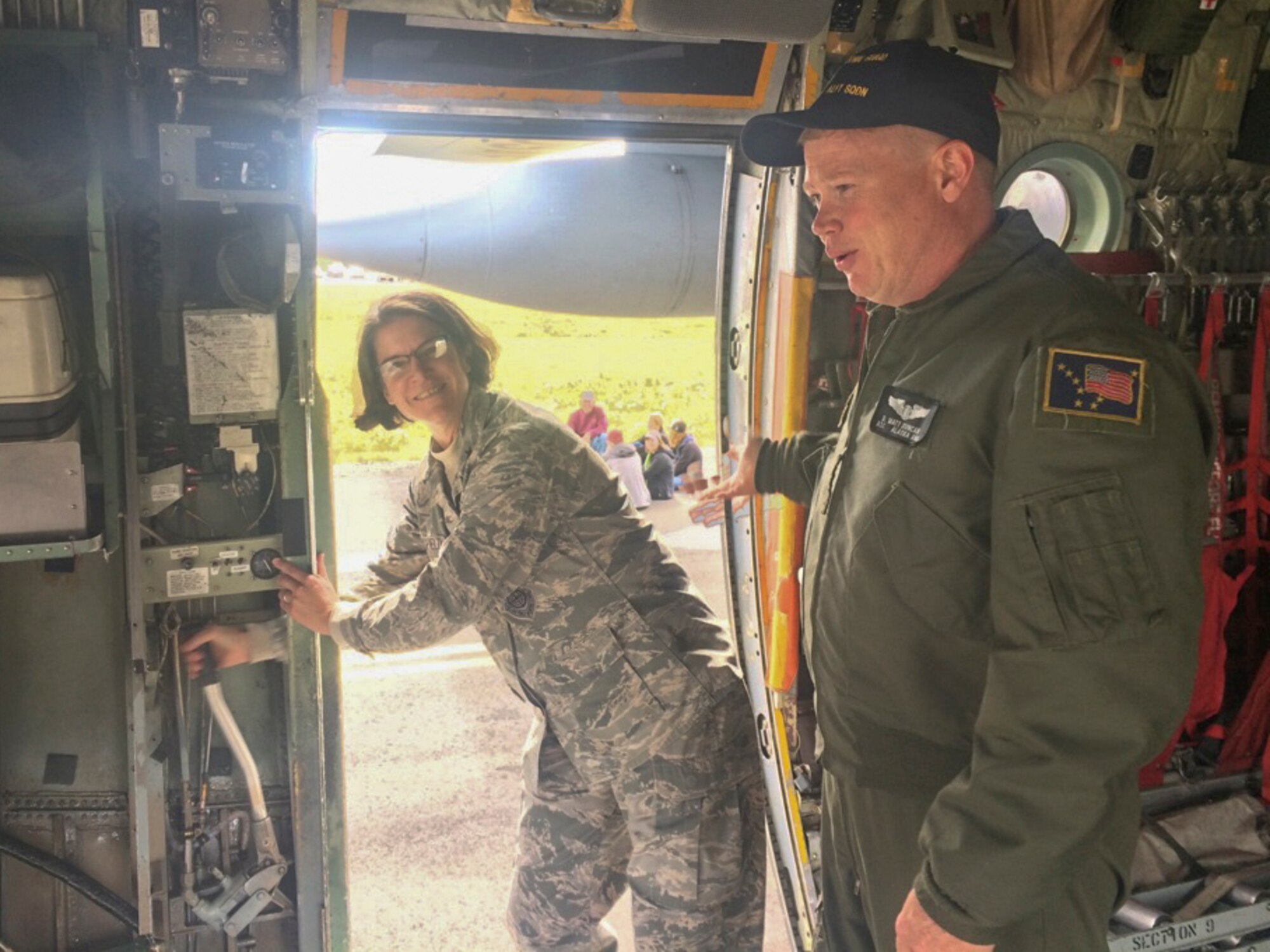 JOINT BASE ELMENDORF RICHARDSON, Alaska -- Brig. Gen. Karen Mansfield, the Assistant Adjutant General of the Alaska Air National Guard, assists C-130 Hercules crew members here Aug. 6 by manually pumping the ramp doors at the 176th Wing family day event since safety precluded the use of engine assistance.  Wing members and their families celebrated Wing Family Day 2016 at Bryant Army Airfield. Family Day is an annual celebration providing family members and guests the opportunity to come to base and observe military demonstrations in a fun, relaxed atmosphere.