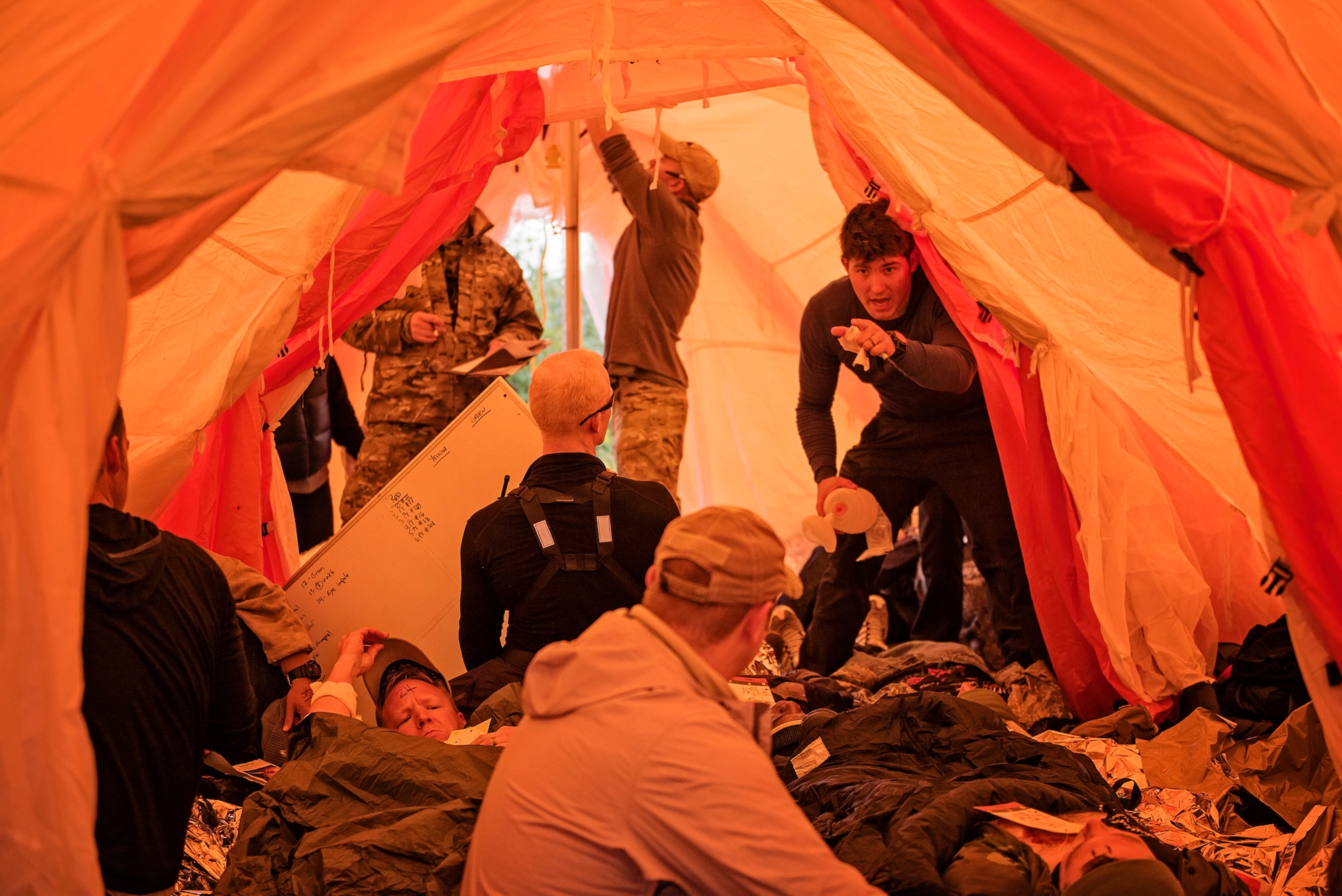 Pararescuemen from the 212th Rescue Squadron, Alaska Air National Guard, triage simulated casualties inside their Arctic Sustainment Package tent during exercise Arctic Chinook, near Kotzebue, Alaska, August 23. Arctic Chinook is a joint U.S. Coast Guard and U.S. Northern Command sponsored exercise which focuses on multinational search and rescue readiness to respond to a mass rescue operation requirement in the Arctic. (U.S. Air National Guard photo by Staff Sgt, Edward Eagerton/released)
