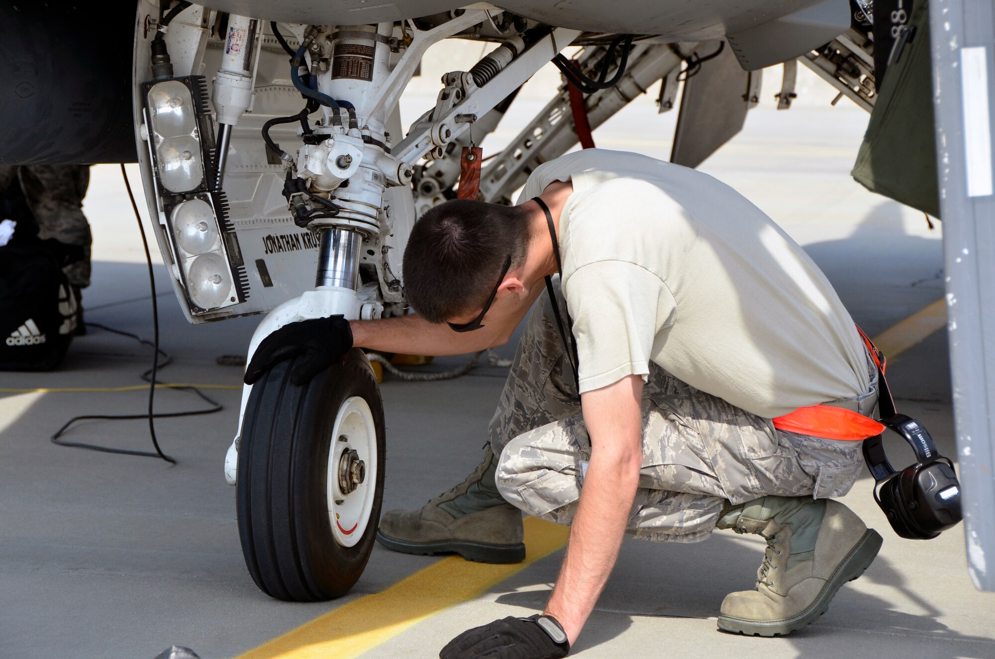 Lask Air Base, Poland -- Tech. Sgt. Scott Schmit, 114th Aircraft Maintenance Squadron crew chief, inspects a nose tire on an F-16 Fighting Falcon after arriving here Sept. 3. A thorough inspection is accomplished after each flight to ensure the jet is safe and ready to fly the next mission.  (U.S. Air National Guard photo by Capt. Amy Rittberger/Released)