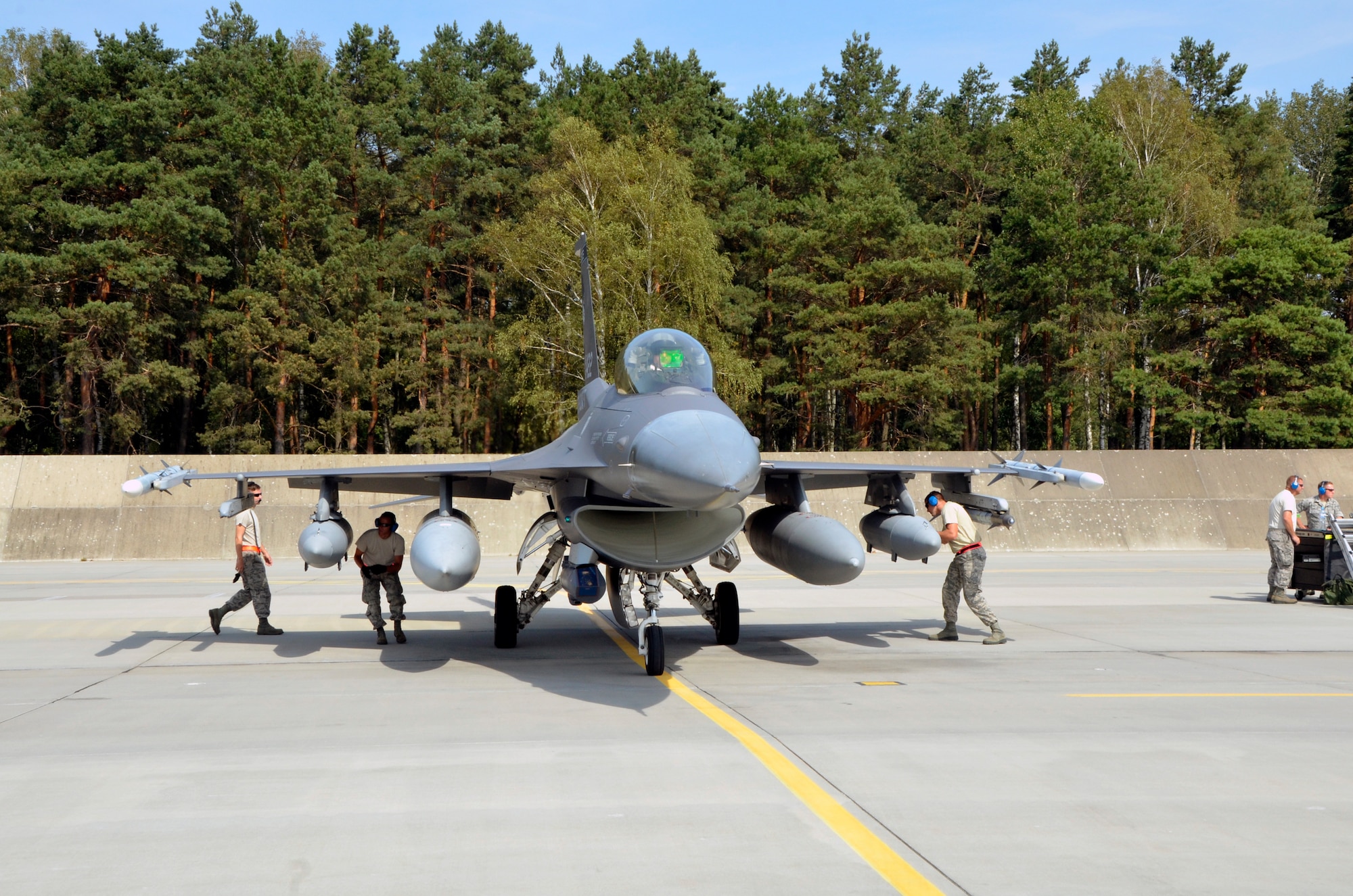 Lask Air Base, Poland -- Members of the South Dakota Air National Guard 114th Maintenance Group immediately began an initial cursory inspection of an F-16 Fighting Falcon upon arrival here Sept. 3. Additional recovery procedures are then performed after the aircraft is shut down. (U.S. Air National Guard photo by Capt. Amy Rittberger/Released)