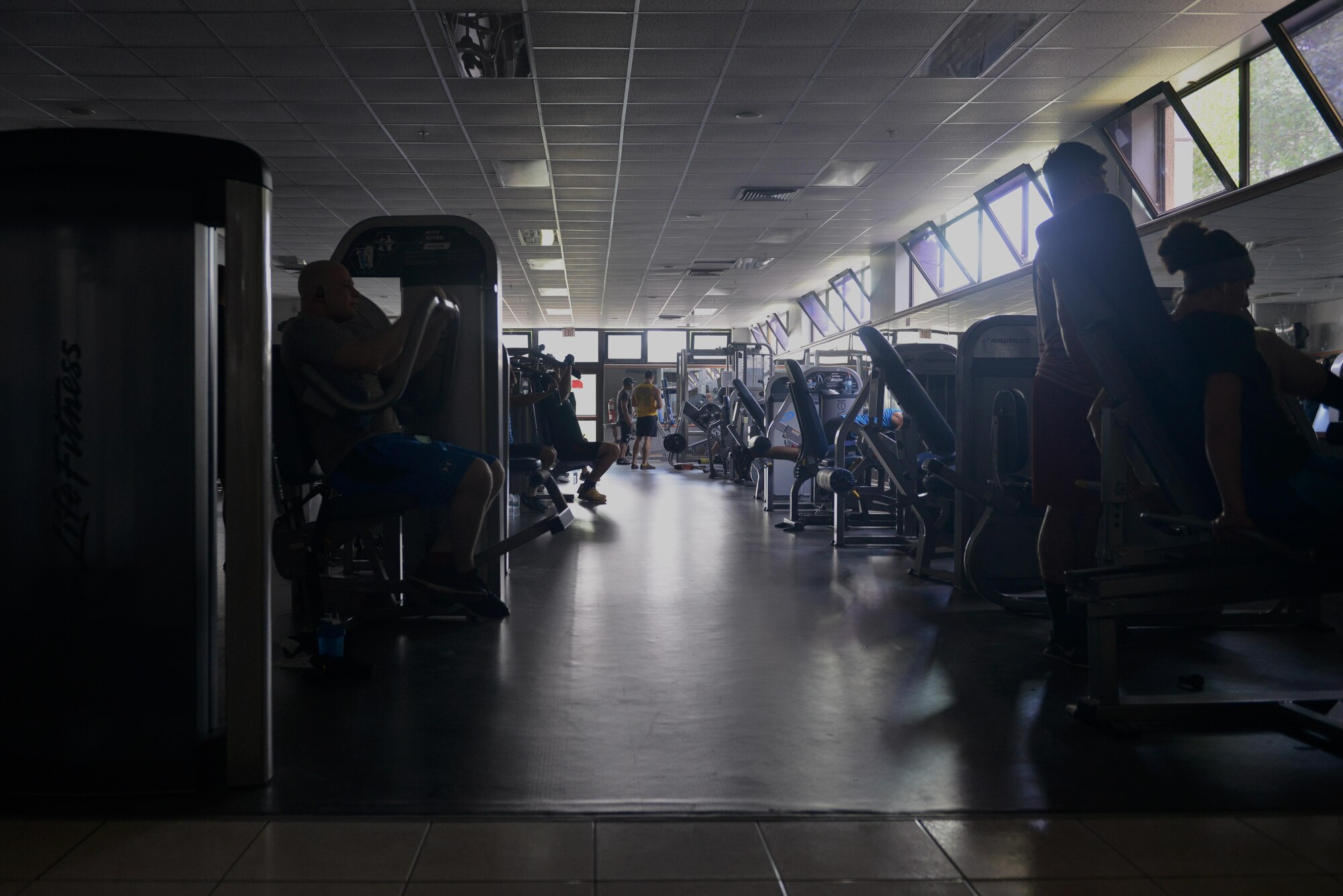 U.S. Air Force Airmen work out with limited electricity at the fitness center at Incirlik Air Base, Turkey, July 21, 2016. Due to a temporary loss of commercial power, some facilities had to continue operations, including the base's fitness center until power was completely restored. (U.S. Air Force photo by Senior Airman John Nieves Camacho) 