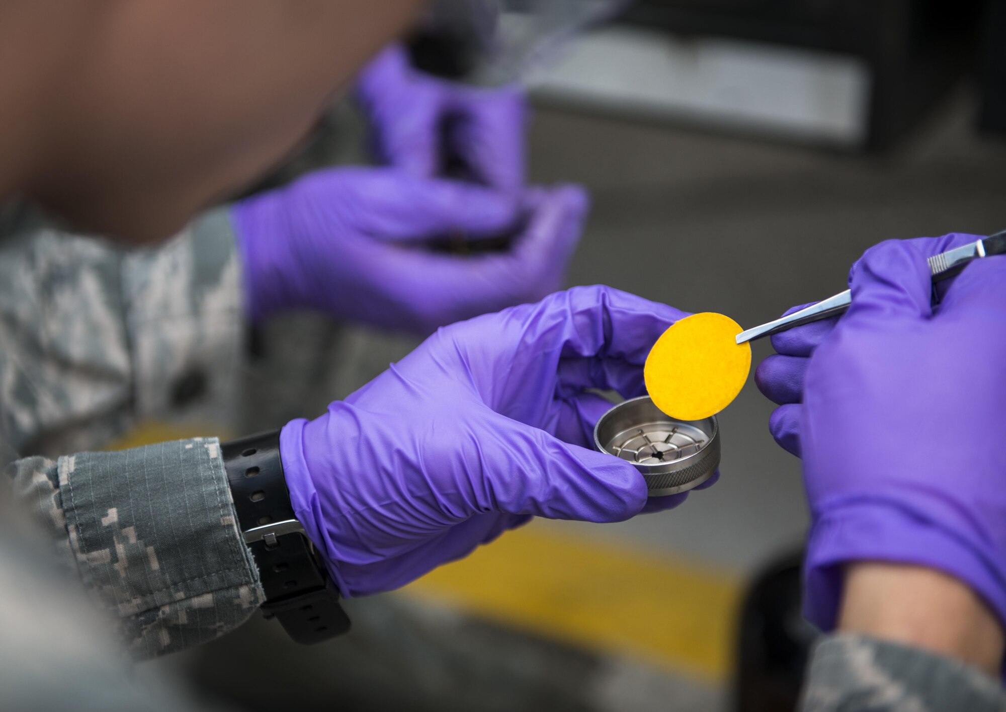 Airman 1st Class Chandler Adams, 31st Logistics Readiness Squadron fuels laboratory technician, examines a filter used to test fuel at Aviano Air Base, Italy, Sept. 7, 2016. Some contaminants are invisible to the naked eye, so fuel must be put through a series of tests to help identify them. (U.S. Air Force photo by Airman 1st Class Cory W. Bush/Released)