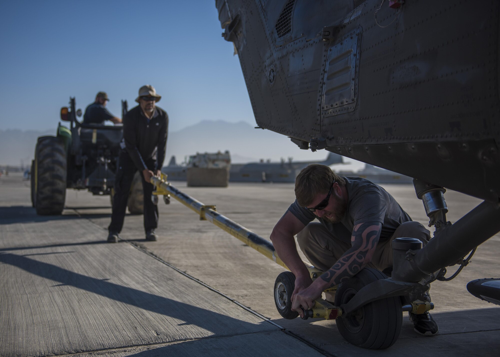 Michael Ballew, Department of Defense contractor, connects a tow bar to a Sikorsky UH-60 Blackhawk, Bagram Airfield, Afghanistan, Sept. 8, 2016. When Army aircrew units redeploy back to their home stations, the Blackhawks are packed up and transported back on aircraft such as the C-5 Galaxy. As the Air Force’s largest strategic airlifter, the C-5 can handle a payload of up to 5 helicopters. (U.S. Air Force photo by Senior Airman Justyn M. Freeman)