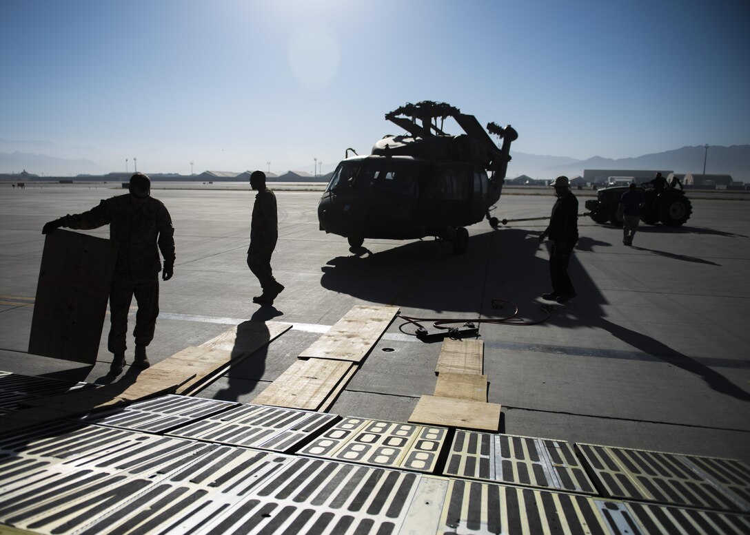 U.S. Army and Air Force aircrew members work with Department of Defense contractors to load UH-60 Blackhawks on to C-5 Galaxy aircraft. As Army aircrew units redeploy, the Blackhawks are packed up and transported back to home stations with the owning units. (U.S. Air Force photo by Senior Airman Justyn M. Freeman)