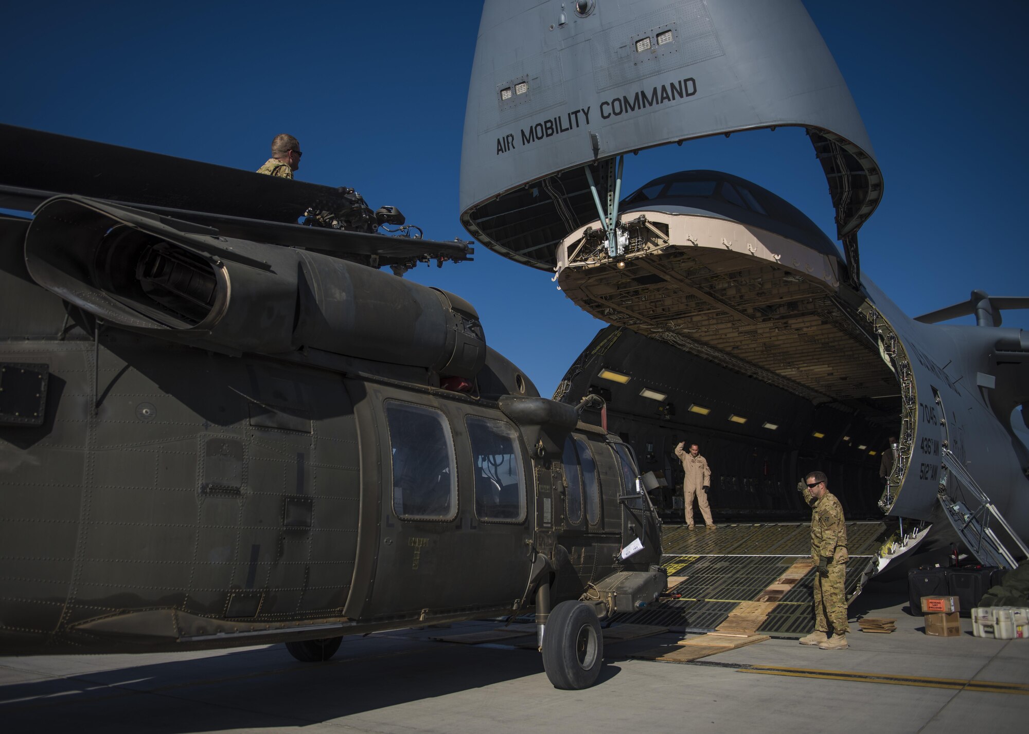 A Sikorsky UH-60 Blackhawk is hauled into a C-5 Galaxy for transport, Bagram Airfield, Afghanistan, Sept. 8, 2016. When Army aircrew units redeploy back to their home stations, the Blackhawks are packed up and transported back on aircraft such as the C-5 Galaxy. As the Air Force’s largest strategic airlifter, the C-5 can handle a payload of up to 5 helicopters. (U.S. Air Force photo by Senior Airman Justyn M. Freeman)